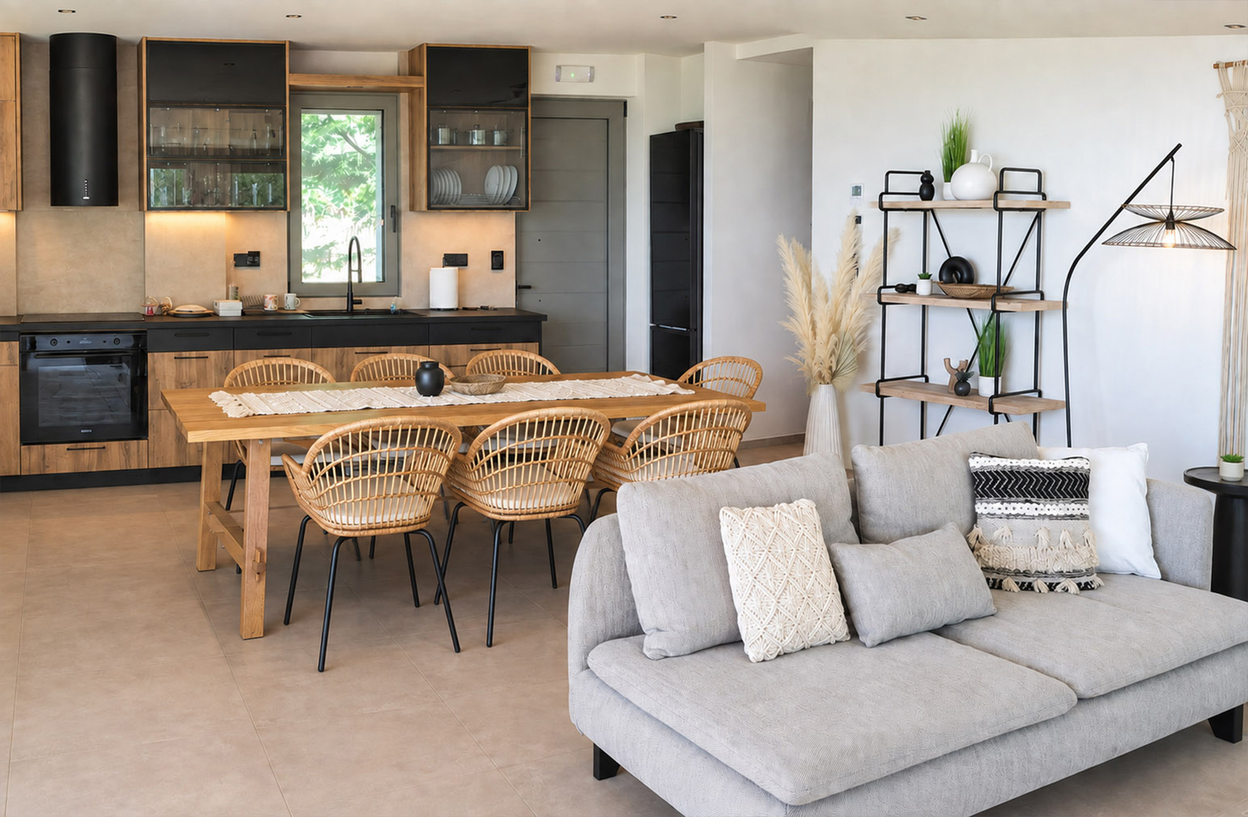 Kitchen and dining area with a dining table, chairs and part of the adjoining sofa in a Skaloma holiday home.