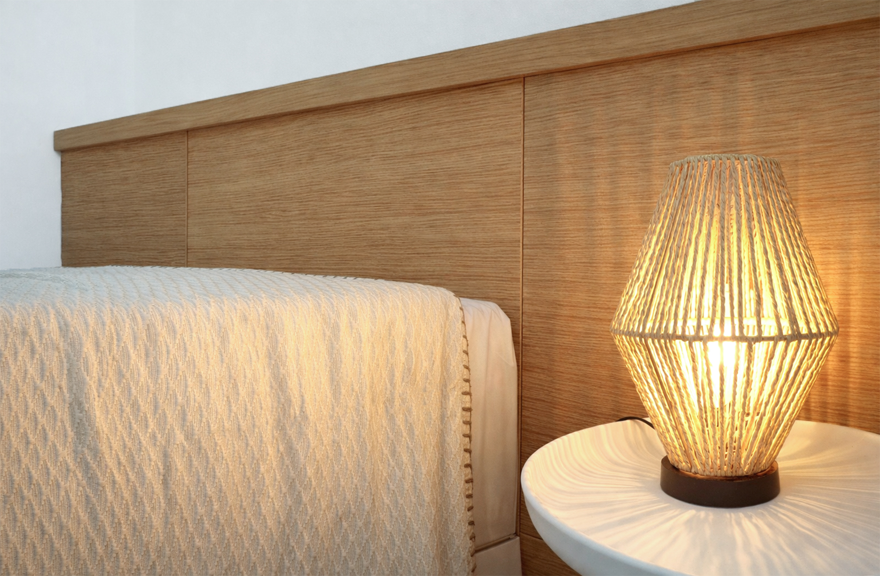 Bedroom detail in an Andros Cycladic residence with woven bedside lamp and custom wood paneling