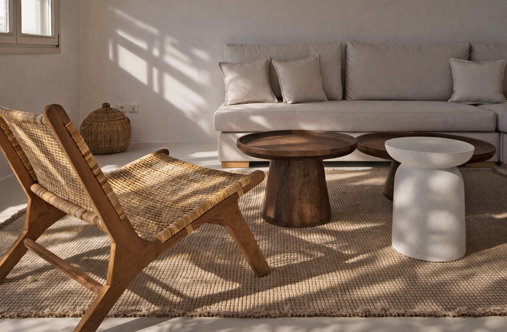Living room interior in an Andros residence with natural wood furniture, woven textures and neutral tones