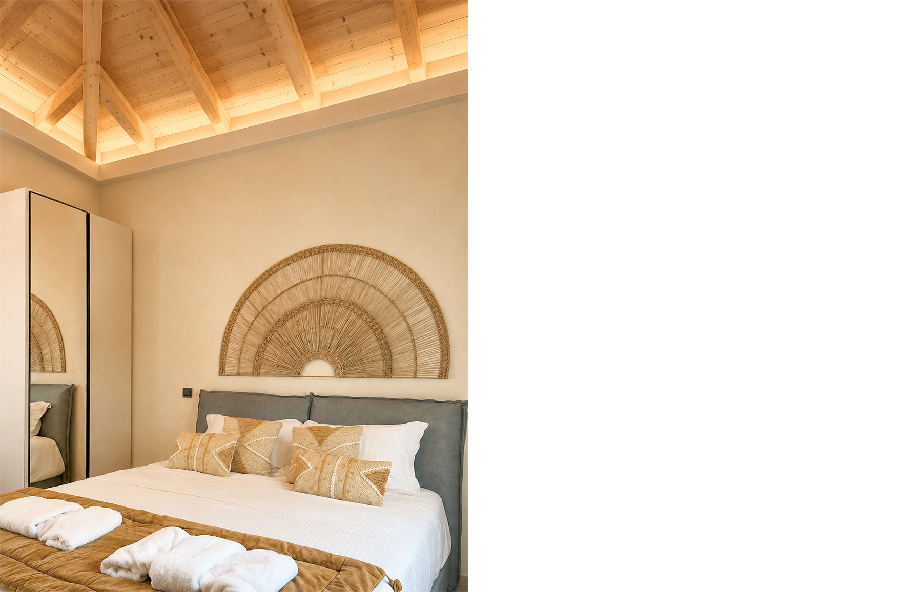 Coastal bedroom with an exposed wooden ceiling, grey upholstered bed and woven wall decoration in a Nafpaktos holiday home.
