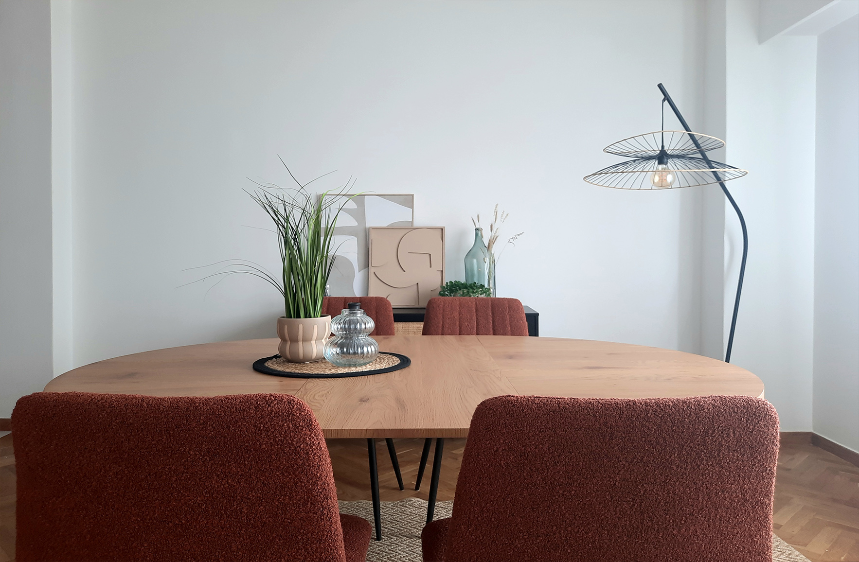 Dining room with wooden table and upholstered chairs in the Plaka guest apartment