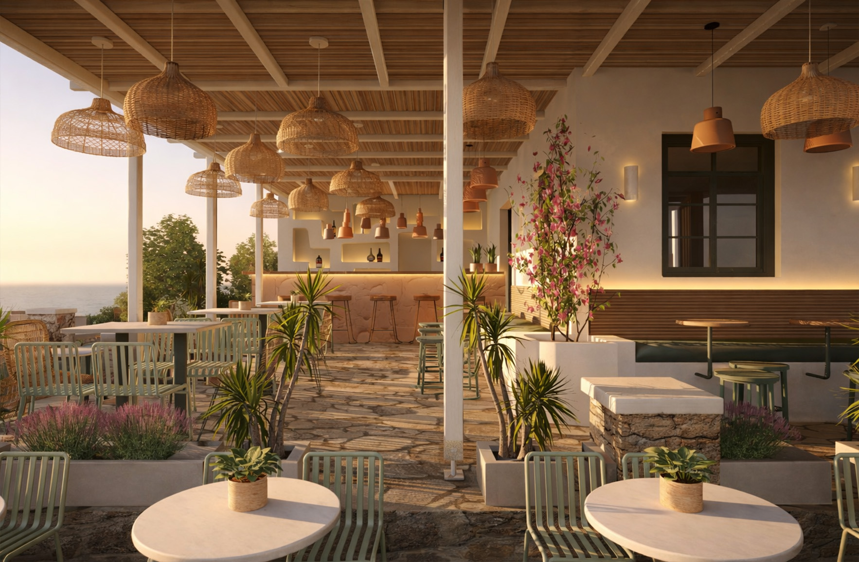 Outdoor dining area at Tanit Restaurant in Mykonos with pergola, integrated planting, woven pendant lights and sea view at sunset.